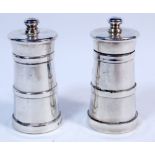 A pair of silver salt and pepper grinders, 9cm tall