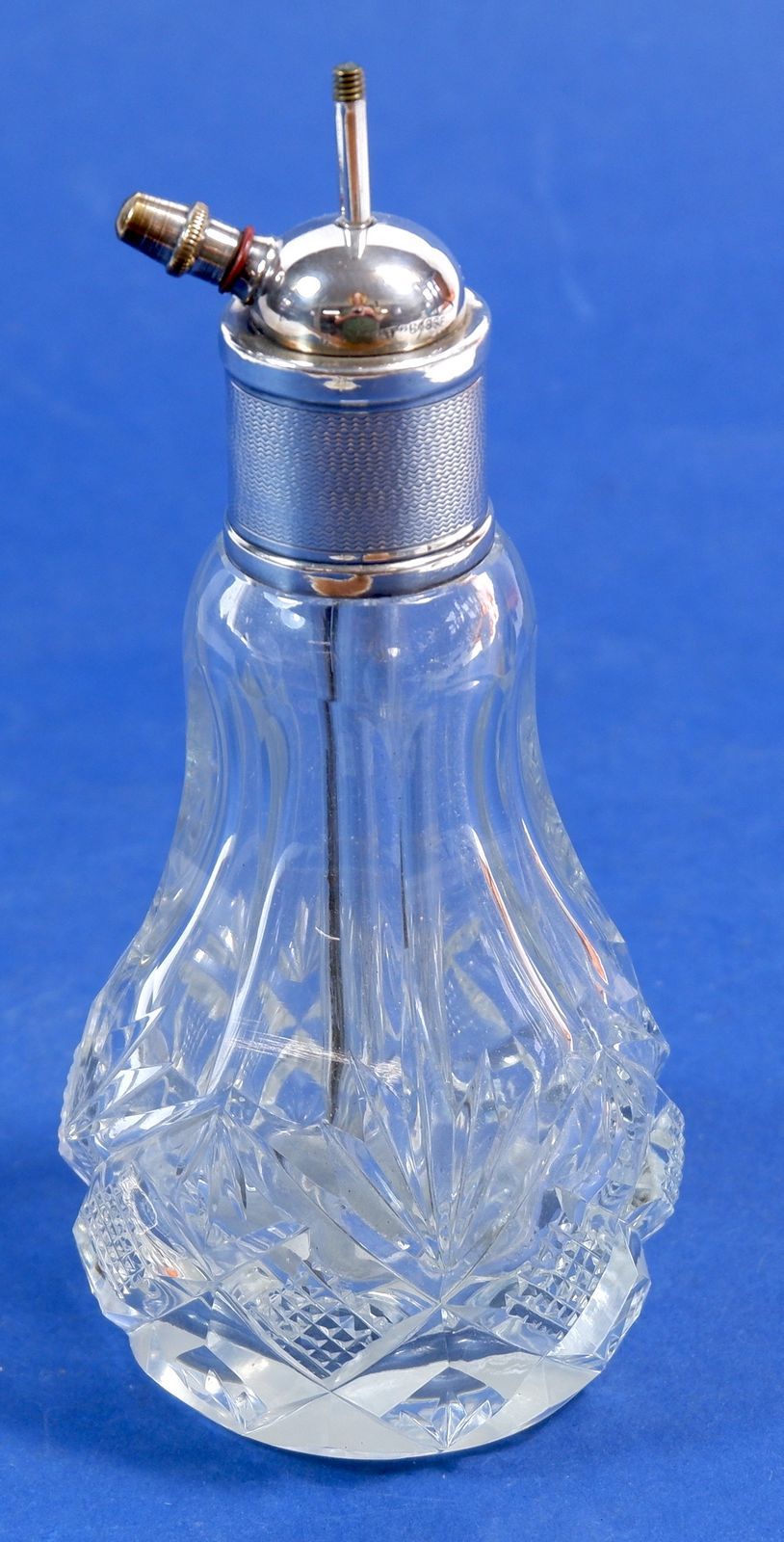 A silver topped cut glass atomiser, Birmingham 1929, 15cm tall, missing atomiser puff
