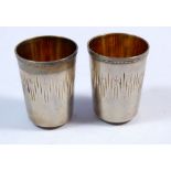 Two Russian silver vodka cups with star and channel cut decoration