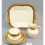 A Cauldon blue and gilt tea service comprising: nine cups and eleven saucers, twelve tea plates, two