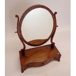 A Victorian oval mahogany swing toiletry mirror with chevron inlay and box base, 46cm wide