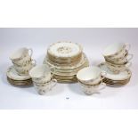 A Royal Doulton Mandalay tea service comprising nine cups and saucers, nine tea plates, six side