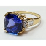 An 18 carat white gold AAA tanzanite ring, the central stone 7.8cts on baguette and brilliant cut