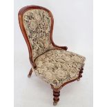 A Victorian mahogany framed salon chair on turned supports