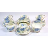 A Sutherland blue floral tea service comprising six cups and saucers, six tea plates and sugar bowl