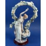 A Lladro group No 6571, 'Rebirth' with stand, boxed - good condition all flowers present