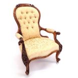 A Victorian carved walnut framed button upholstered chair