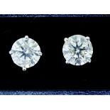 A pair of 14 carat white gold large diamond stud earrings, one carat each, for pierced ears with