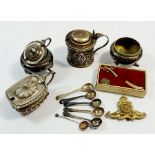 A small silver salt, four silver plated cruets and spoons, artillery cap badge and dagger tie pin
