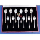A set of twelve silver tea and coffee spoons, cased with examples of British Hallmarks by
