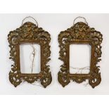 A pair of 19th century cast metal photograph frames decorated cherubs and scrollwork, 24 x 16cm