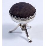 A silver pin cushion in the form of a stool with hinged lid, the interior lined with silk and fitted