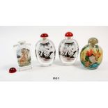 A pair of Chinese glass panda snuff bottles and two other snuff bottles