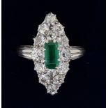 An 18 ct gold marquise diamond and emerald ring, 2.4 x 1cm, Size N