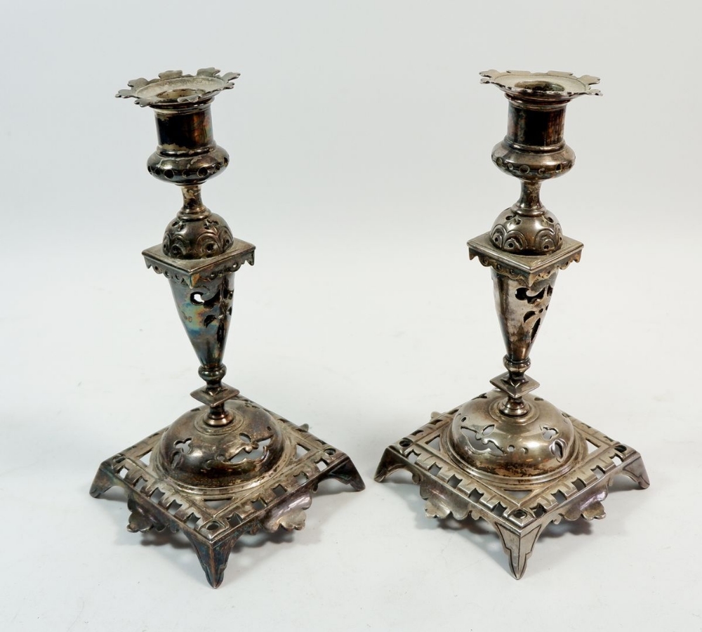 A pair of silver plated pierced candlesticks, 22cm tall