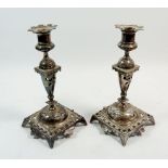 A pair of silver plated pierced candlesticks, 22cm tall