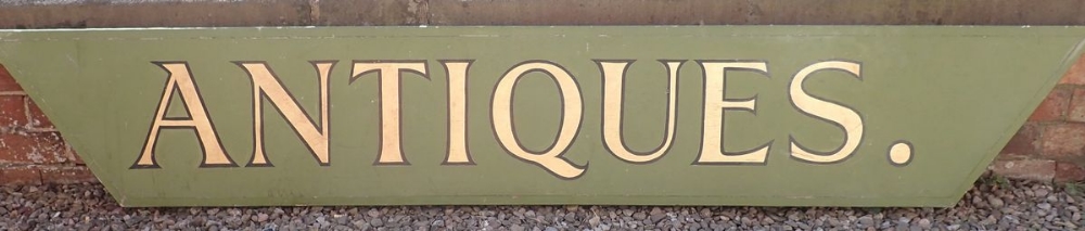 A large wooden hand painted 'Antiques' shop display sign for outside shop frontage, 235cm x 38.5cm