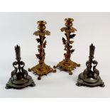 A pair of gilt metal candlesticks decorated oak leaves on paw feet, 22cm tall and a pair of pewter