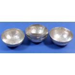 Four Malay white metal bowls with engraved floral decoration, 12cm diameter, 255g