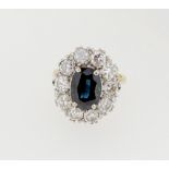 An 18 carat gold large oval sapphire and diamond set ring, size M, 5.3g