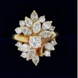 An 18 carat gold ring set asymmetrical arrangement of brilliant and marquise cut diamonds, size M to