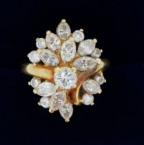 An 18 carat gold ring set asymmetrical arrangement of brilliant and marquise cut diamonds, size M to