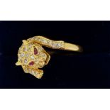 An 18 carat gold diamond leopard ring with ruby eyes, size K