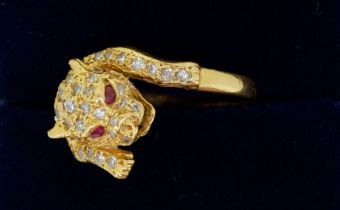 An 18 carat gold diamond leopard ring with ruby eyes, size K