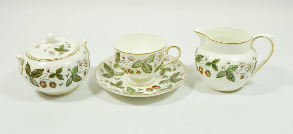 A wedgwood tea service 'Strawberry Hill' comprising 13 cups and saucers, 2 sugar, milk, 3 jugs, 14