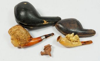 A Meerchaum and amber pipe in the form of a ladies head - cased, another meerchaum pipe - a/f and