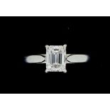 A fine platinum set solitaire diamond ring, the emerald cut stone 1.06 cts, size M to N, with FGA