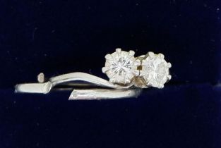 A white metal ring crossover set two diamonds - a/f, band a/f total weight 4.6g