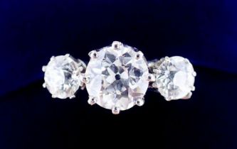 A fine quality platinum set three stone diamond ring, 2.5 cts in total, size M