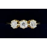 An 18 carat gold three stone diamond ring (total weight 0.93 cts) size Q