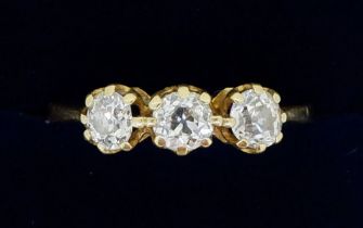 An 18 carat gold three stone diamond ring (total weight 0.93 cts) size Q