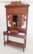 A Victorian carved oak hallstand with dragon and foliage decoration, 103 x 31cm x 210cm