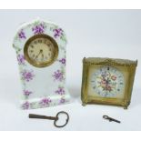 A vintage gilt and embroidered boudoir clock and an Edwardian floral porcelain clock, 18cm tall