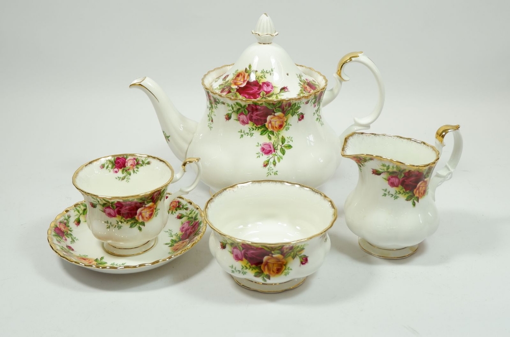 A Royal Albert Country Roses tea service comprising: teapot, eleven cups, seven saucers, eight tea