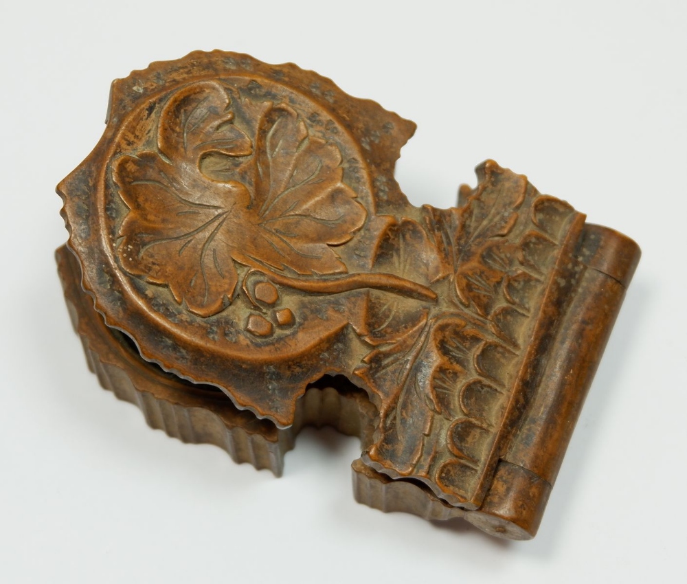 An 19th century carved wooden pocket watch holder with leaf design