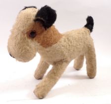 An early 20th century soft toy terrier dog, 23cm long