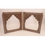 A pair of antique carved oak gothic arch framed open panels with vine and flower decoration