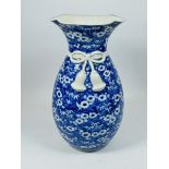 A Japanese blue and white prunus blossom vase with tassel tied design neck, 30cm tall, mark to base