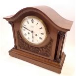 A vintage J W Bensons walnut eight day striking mantel clock with French movement, pendulum and key,