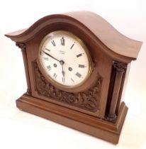 A vintage J W Bensons walnut eight day striking mantel clock with French movement, pendulum and key,