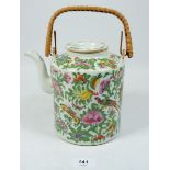 A Chinese Canton Qing dynasty teapot with floral decoration and cane handle, pot 17cm