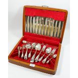 A collection of various silver plated cutlery in a wooden cutlery box