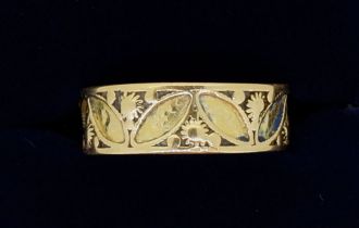 A 9 carat gold ring with stylised leaf and flower decoration (originally enamelled) 2.5g, size M