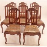 A set of eight French slat back dining chairs with trellis and scrollwork carved top rail