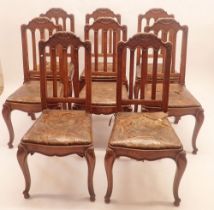 A set of eight French slat back dining chairs with trellis and scrollwork carved top rail