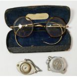 A pair of tortoiseshell spectacles cased, a coin cigarette lighter and compass fob